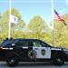 Hingham Police vehicle and Veterans Memorial, flag
